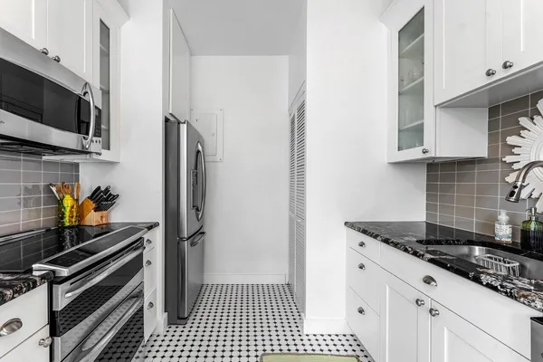 a kitchen with stainless steel appliances a stove and a refrigerator
