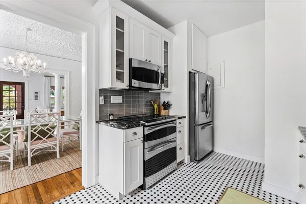 a kitchen with stainless steel appliances a stove a sink and a refrigerator
