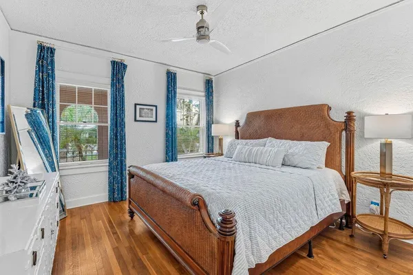 a bed sitting in a bedroom next to a window