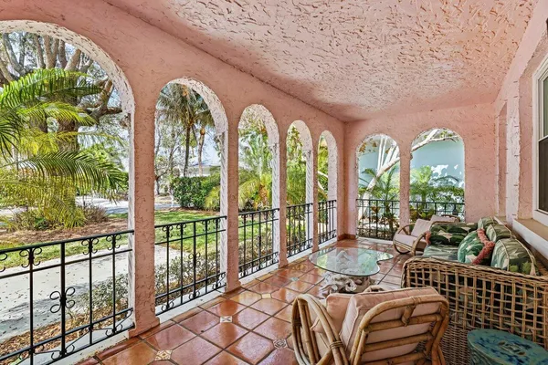 a bedroom with furniture and large windows