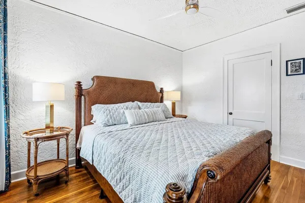 a bedroom with a bed and a lamp on wall