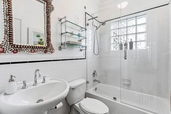 a bathroom with a sink toilet and shower