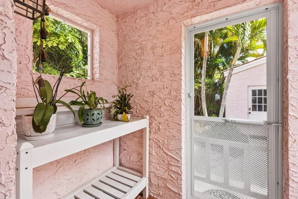 a potted plant sitting on a window sill and a wooden wall