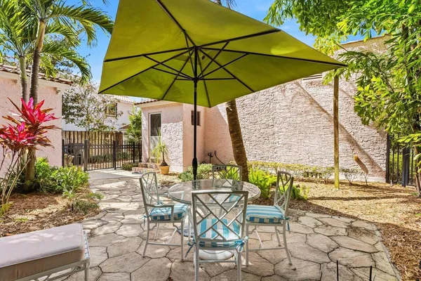 a view of an outdoor space with furniture and umbrella