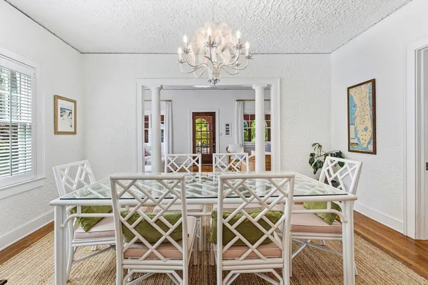 a view of a dining room with furniture and chandelier