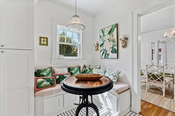 a view of a dining room with furniture and chandelier