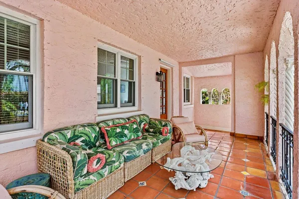 a living room filled with furniture and a potted plant
