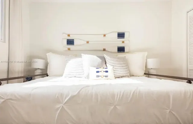 a bedroom with a bed and a night stand