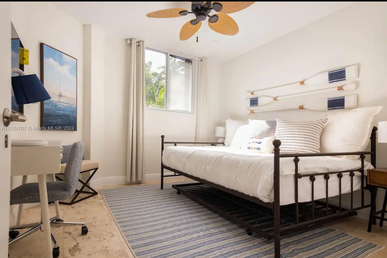 Village of Key Biscayne Key Biscayne, FL 33149 - Photo 4 of 13 a bedroom with a bed and wooden floor