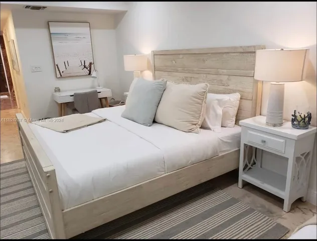 a large white bed in a white room