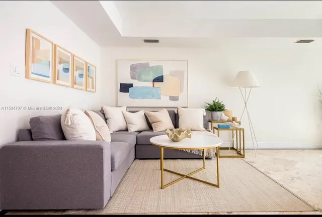 a living room with furniture and a lamp