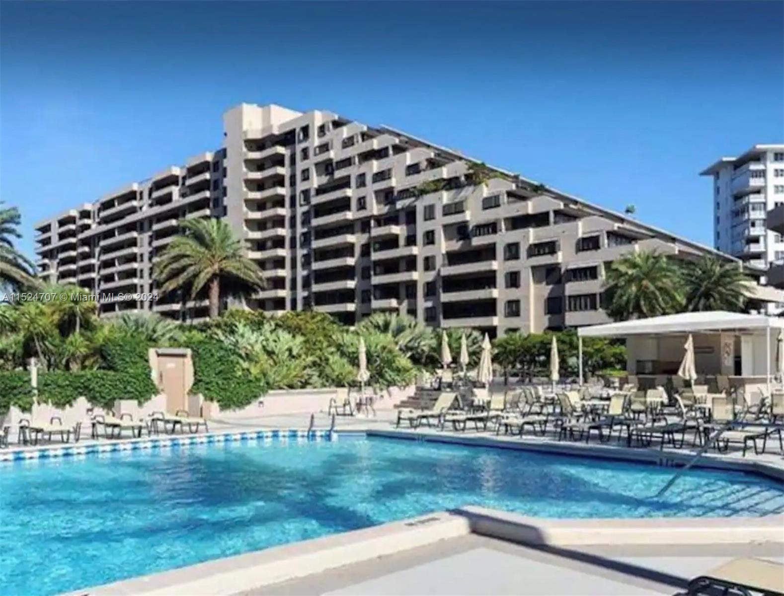 Village of Key Biscayne Key Biscayne, FL 33149 - Photo 10 of 13 a front view of building with outdoor space and swimming pool