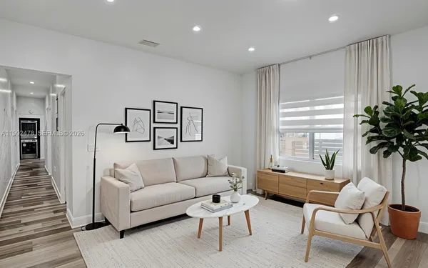 a living room with furniture and a large window