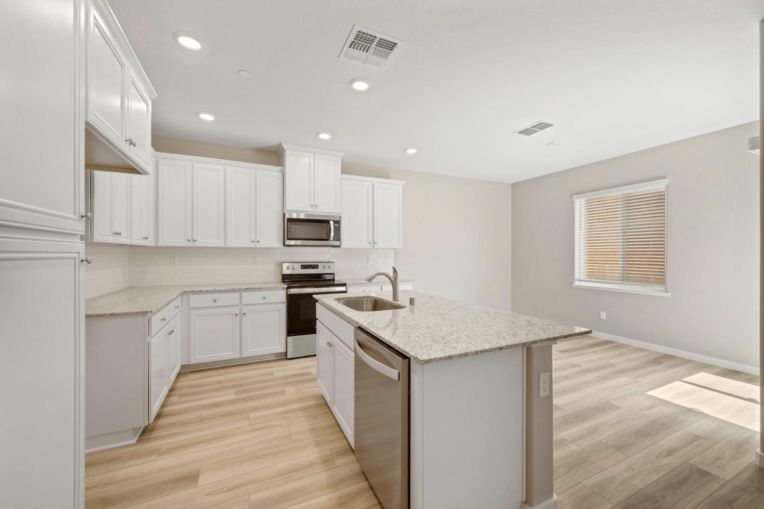 2548 Bog Street Lincoln, CA 95648 - Photo 5 of 21 a kitchen with white cabinets appliances and sink