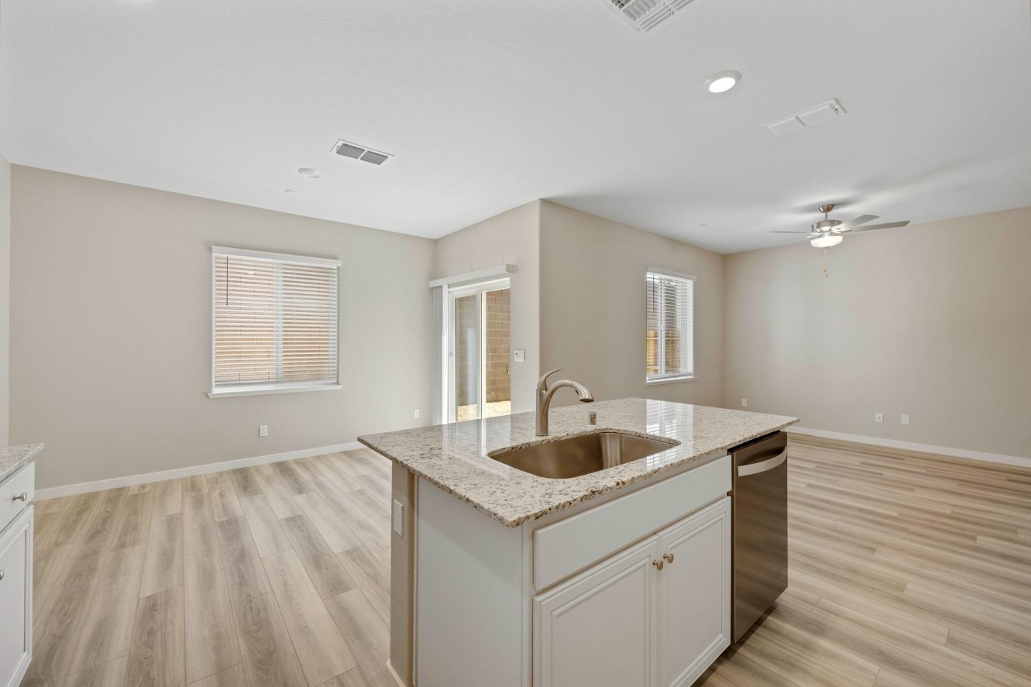 2548 Bog Street Lincoln, CA 95648 - Photo 6 of 21 a kitchen with a sink and chandelier