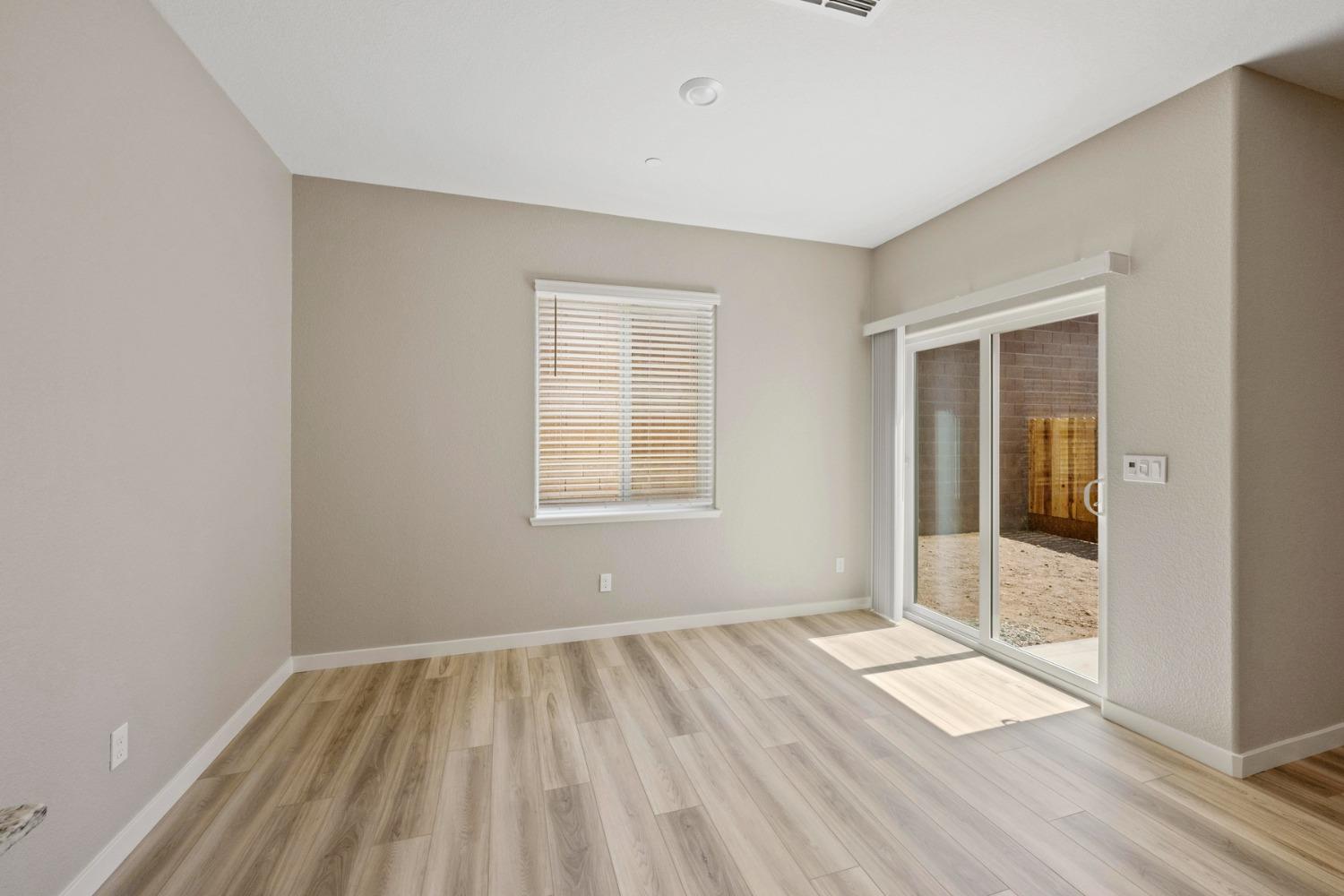 2548 Bog Street Lincoln, CA 95648 - Photo 7 of 21 an empty room with wooden floor and windows