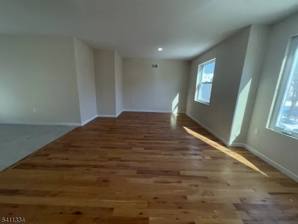 a view of wooden floor and windows in a room