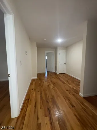 a view of hallway with wooden floor