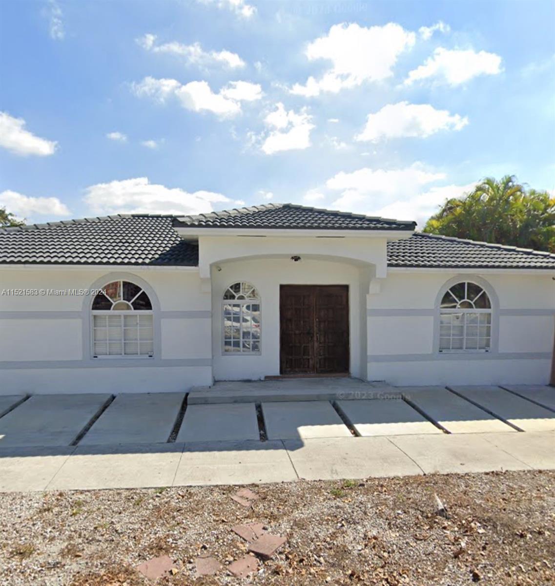 3196 West 79th Place Hialeah, FL 33018 - Photo 1 of 19 a front view of a house with a yard
