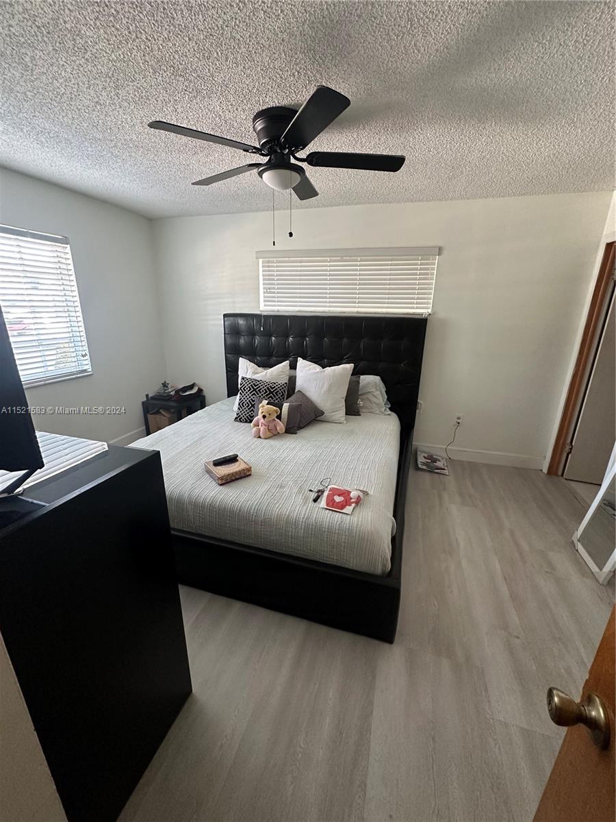 3196 West 79th Place Hialeah, FL 33018 - Photo 11 of 19 a bedroom with a bed and a window