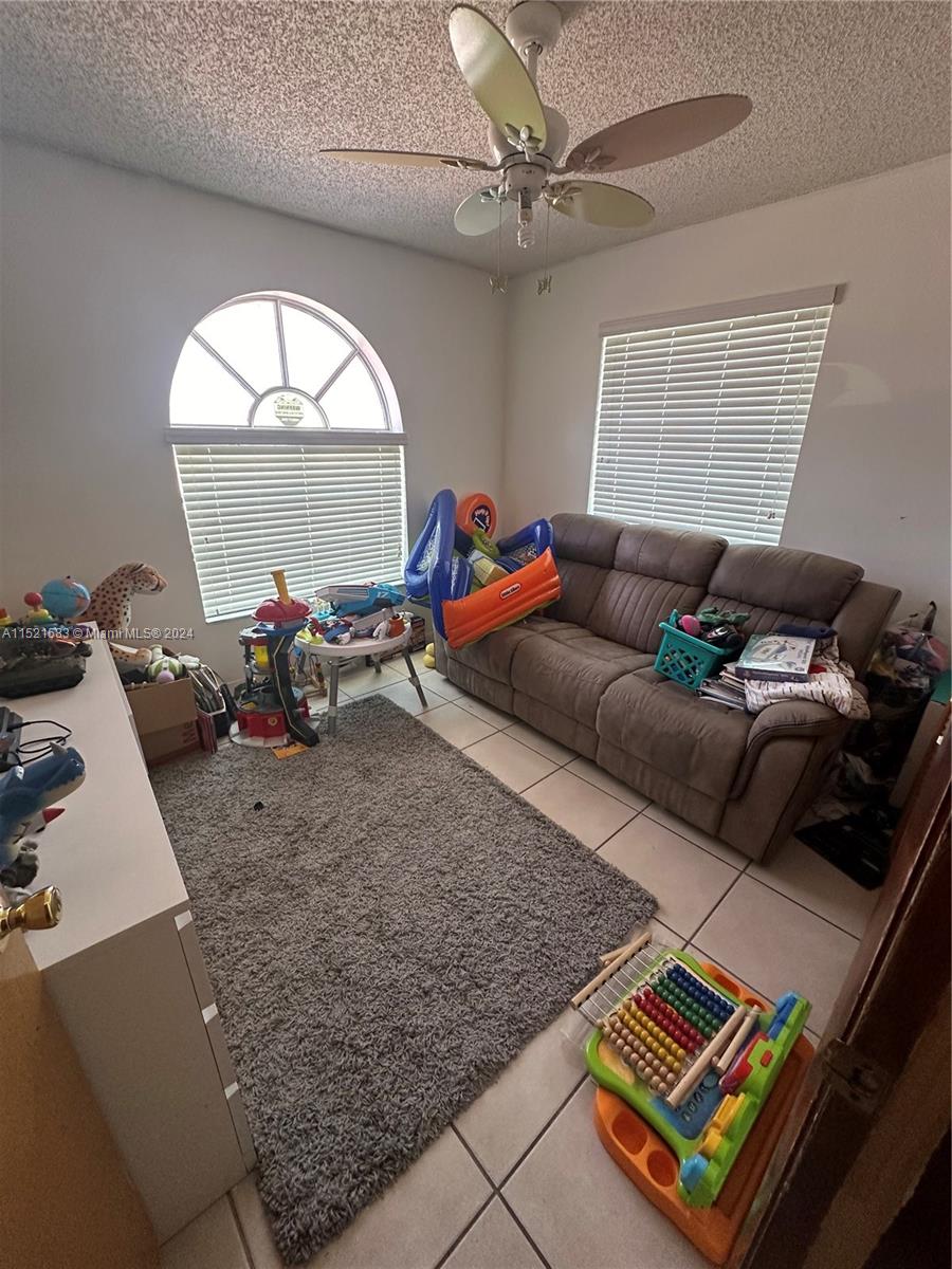 3196 West 79th Place Hialeah, FL 33018 - Photo 12 of 19 a living room with furniture and a window