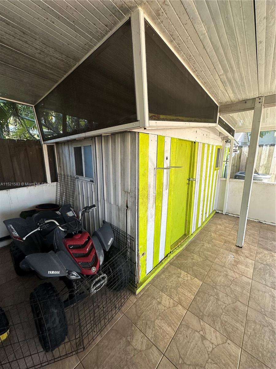 3196 West 79th Place Hialeah, FL 33018 - Photo 18 of 19 a backyard of a house with table and chairs