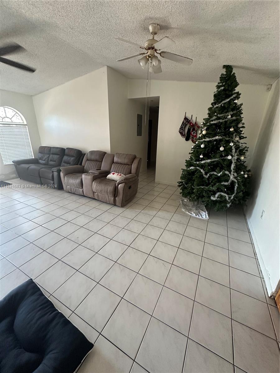 3196 West 79th Place Hialeah, FL 33018 - Photo 5 of 19 a living room with furniture and flowers