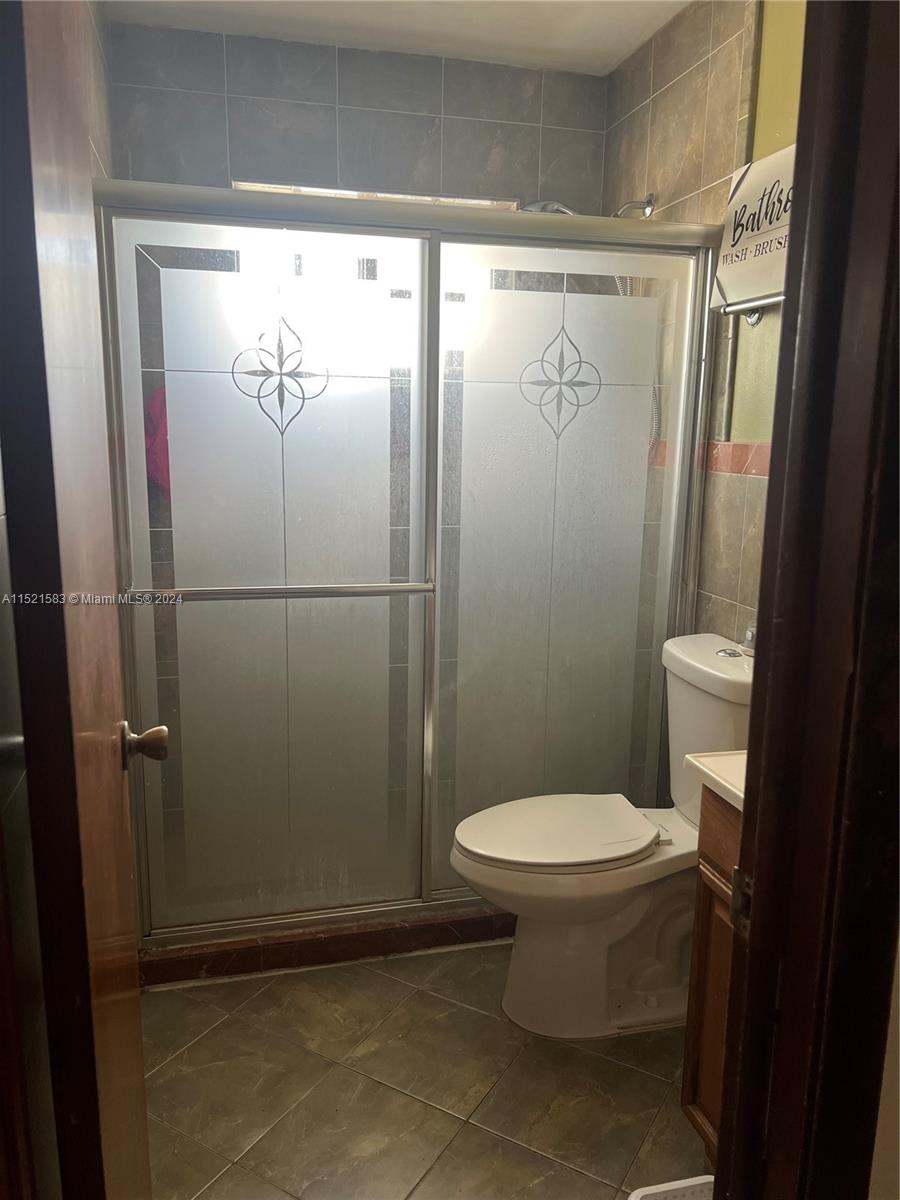 3196 West 79th Place Hialeah, FL 33018 - Photo 7 of 19 a bathroom with a toilet and a shower