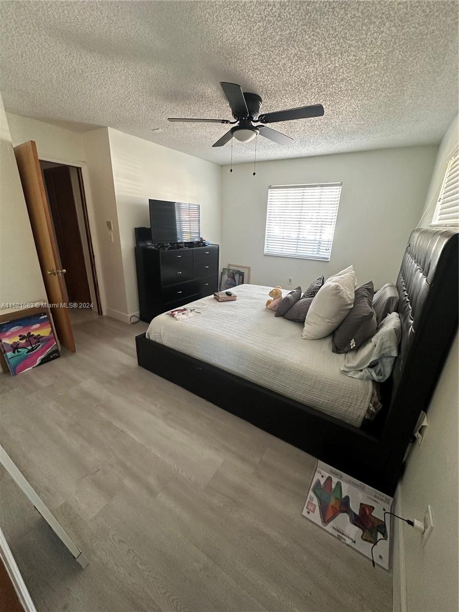 3196 West 79th Place Hialeah, FL 33018 - Photo 10 of 19 a bedroom with a bed and a flat screen tv