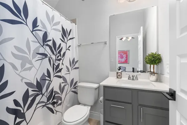 a bathroom with a sink toilet and mirror