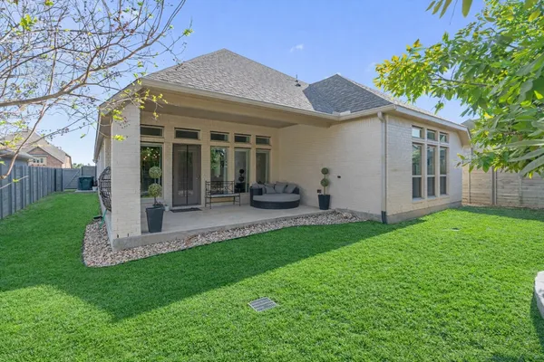an aerial view of a house with garden space and street view