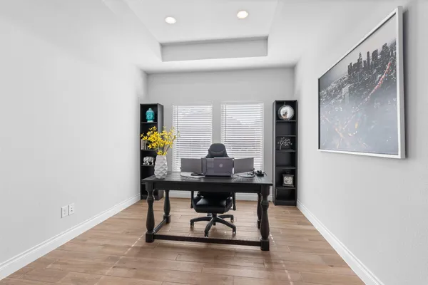 a view of a house with a yard and potted plants
