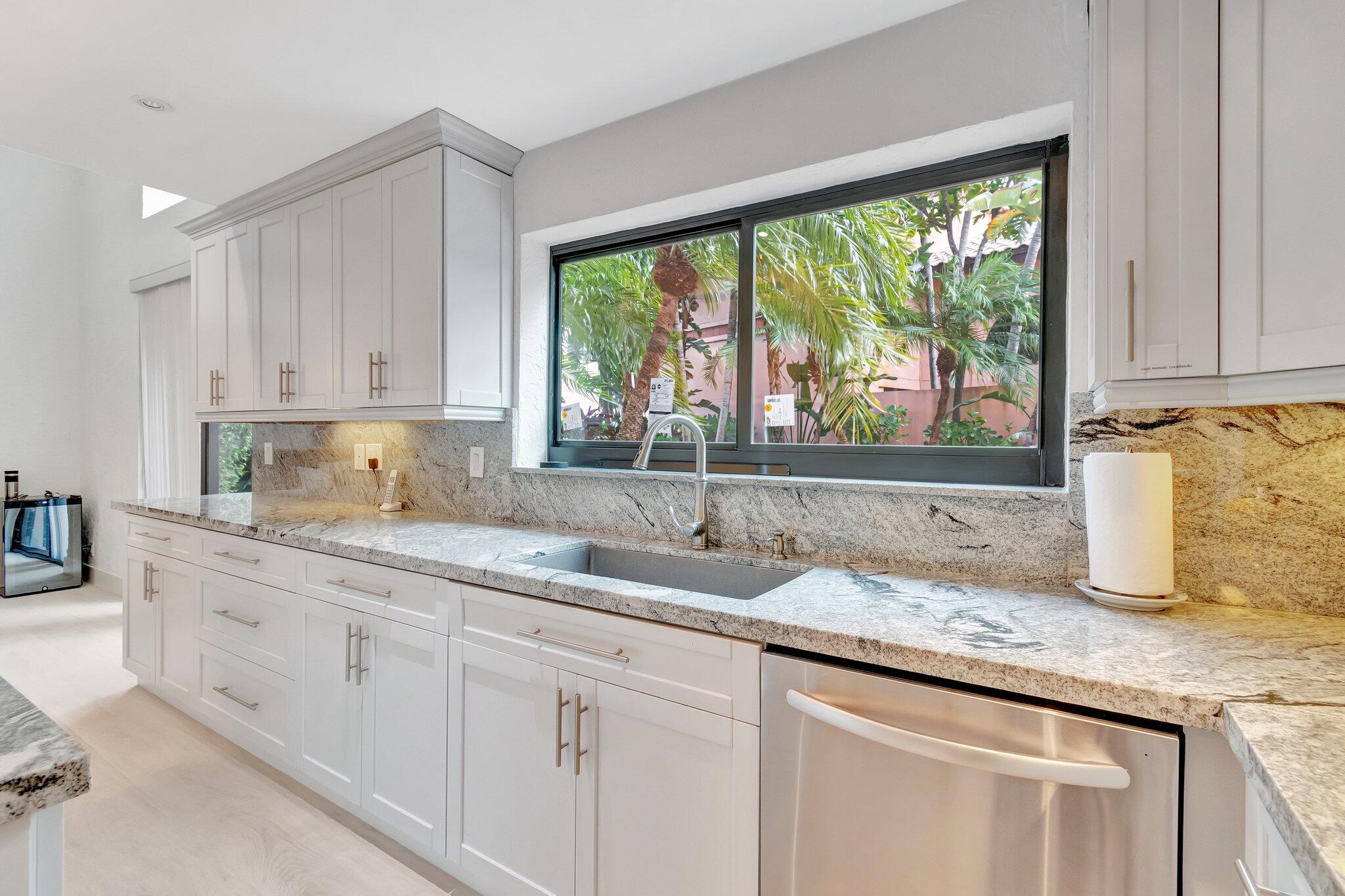 6427 Via Rosa Boca Raton, FL 33433 - Photo 12 of 80 a kitchen with granite countertop white cabinets and a window