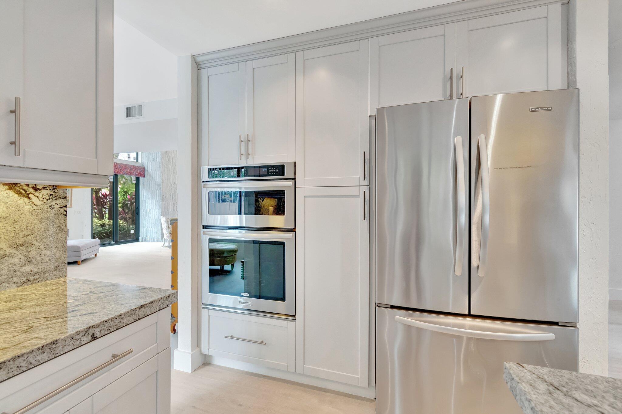 6427 Via Rosa Boca Raton, FL 33433 - Photo 15 of 80 a kitchen with granite countertop stainless steel appliances a refrigerator and cabinets