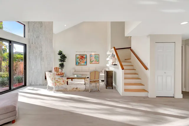 a spacious bedroom with a bed and wooden floor