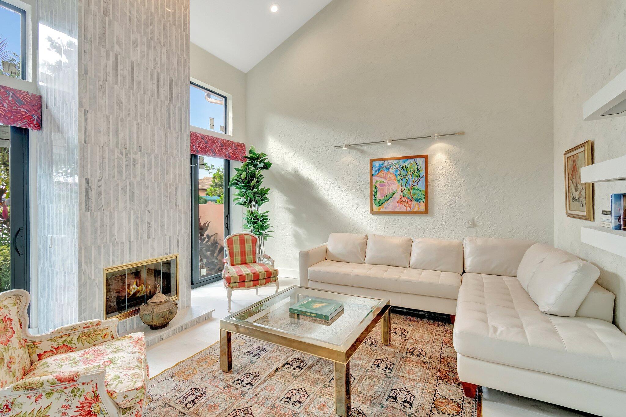 6427 Via Rosa Boca Raton, FL 33433 - Photo 27 of 80 a living room with furniture a fireplace and a table