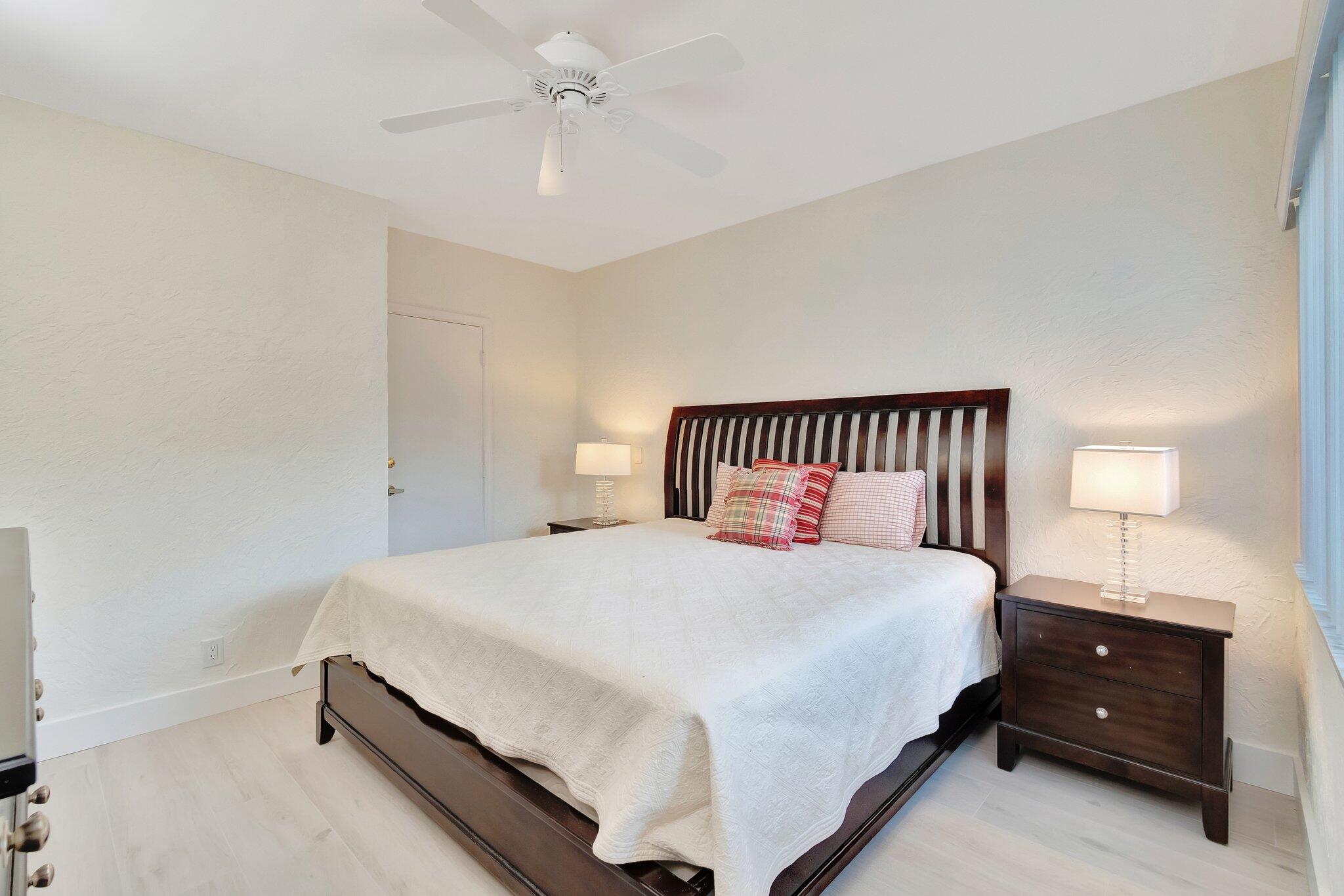 6427 Via Rosa Boca Raton, FL 33433 - Photo 39 of 80 a bedroom with a bed and a ceiling fan