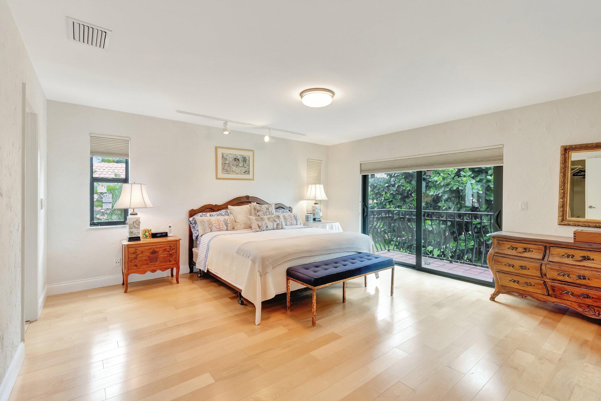 6427 Via Rosa Boca Raton, FL 33433 - Photo 42 of 80 a spacious bedroom with a bed and wooden floor
