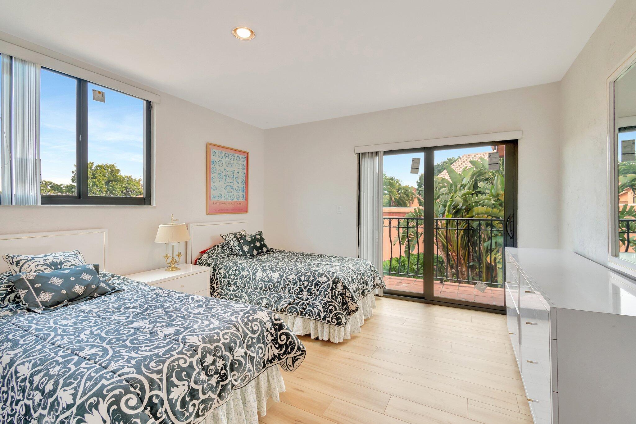 6427 Via Rosa Boca Raton, FL 33433 - Photo 62 of 80 a bedroom with a large bed and a large window