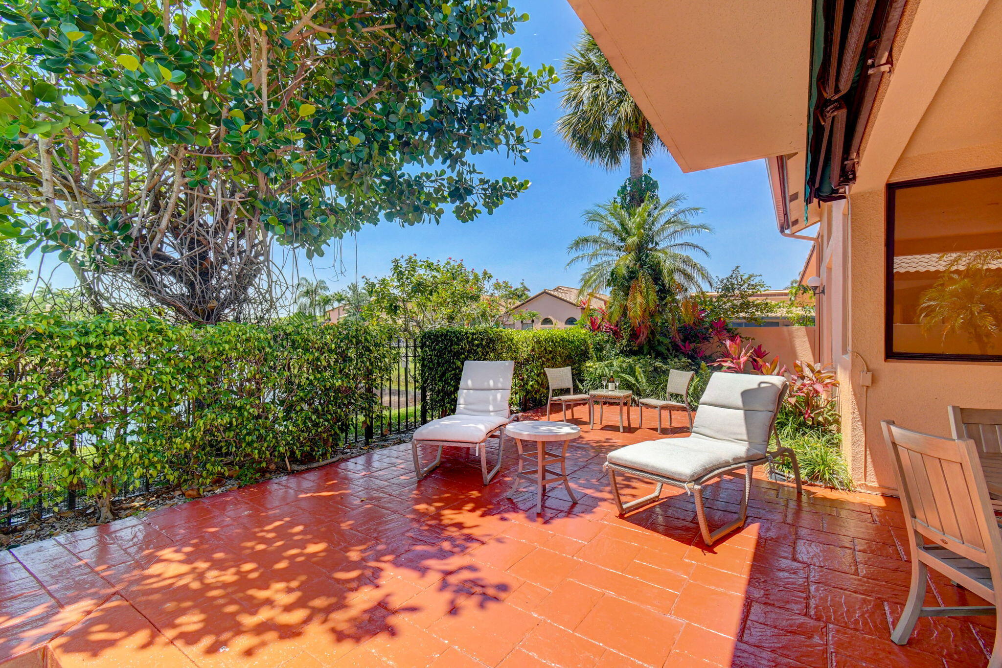 6427 Via Rosa Boca Raton, FL 33433 - Photo 67 of 80 a view of a patio with table and chairs potted plants and large tree