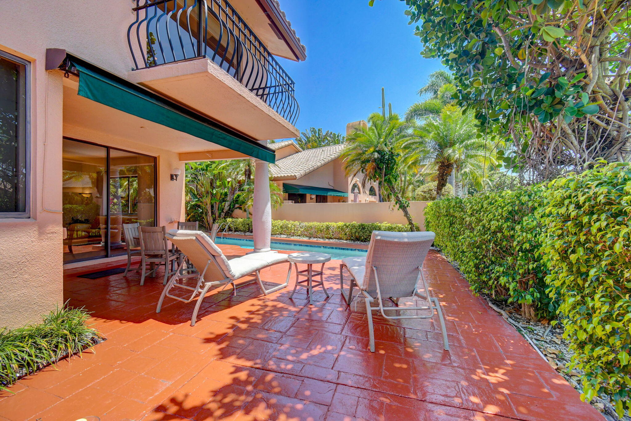 6427 Via Rosa Boca Raton, FL 33433 - Photo 69 of 80 a view of a patio with table and chairs potted plants and floor to ceiling window and potted plants