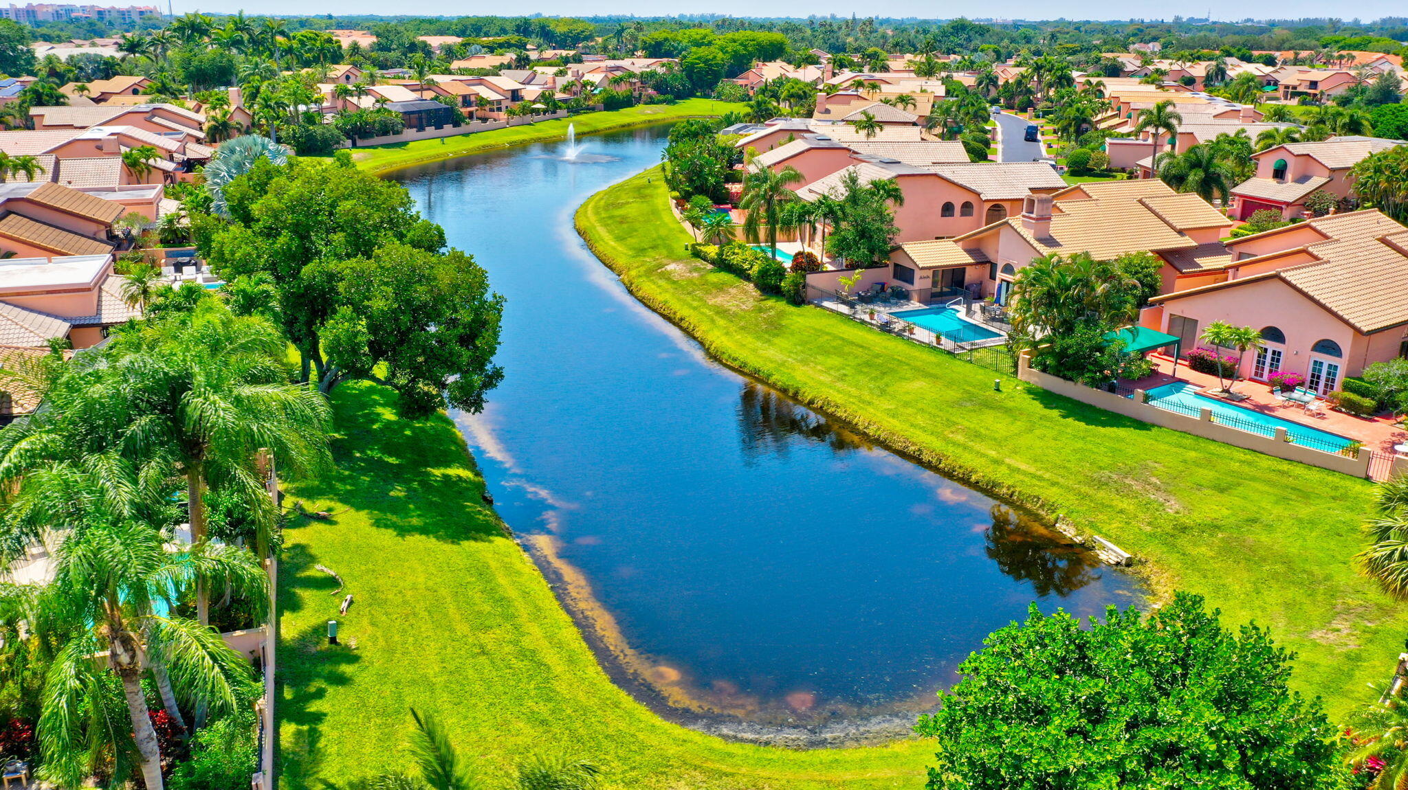 6427 Via Rosa Boca Raton, FL 33433 - Photo 79 of 80 an aerial view of a house with a swimming pool yard and lake view