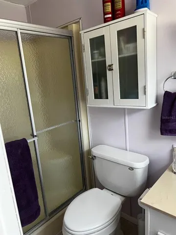 a bathroom with a toilet and a shower