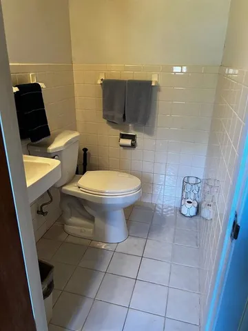 a bathroom with a toilet a sink and a shower