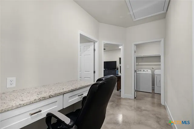 a view of a kitchen cabinets and a refrigerator