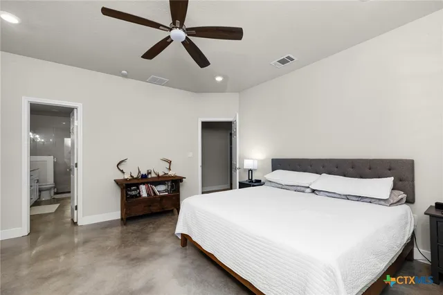 a bedroom with a bed and ceiling fan