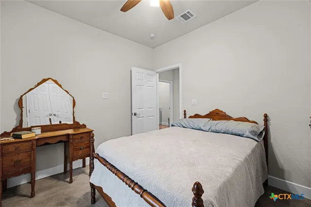 a bedroom with a bed and a desk