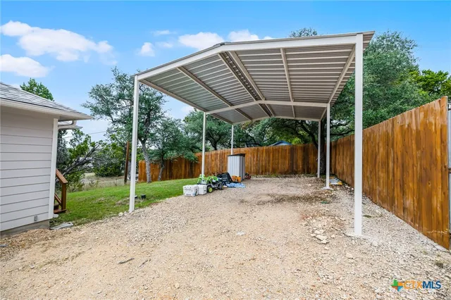 a backyard of a house with plants and outdoor seating