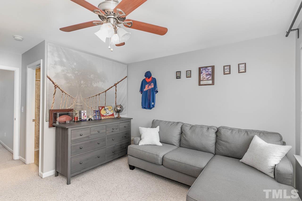 7859 Silverthread Lane Raleigh, NC 27617 - Photo 23 of 25 a living room with furniture and a ceiling fan