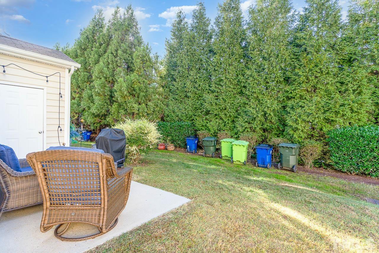 7859 Silverthread Lane Raleigh, NC 27617 - Photo 8 of 25 a backyard of a house with table and chairs